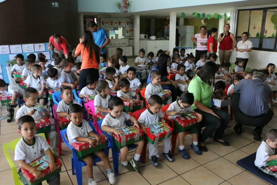 children holding Operation Christmas Child shoeboxes 