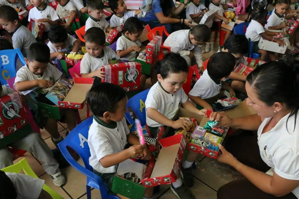 Little boys opening up Operation Christmas Child shoeboxes.