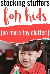 a little Asian girl wearing red Christmas pajamas with a green Christmas tree craft and she is so excited about her non-junk stocking stuffers for kids