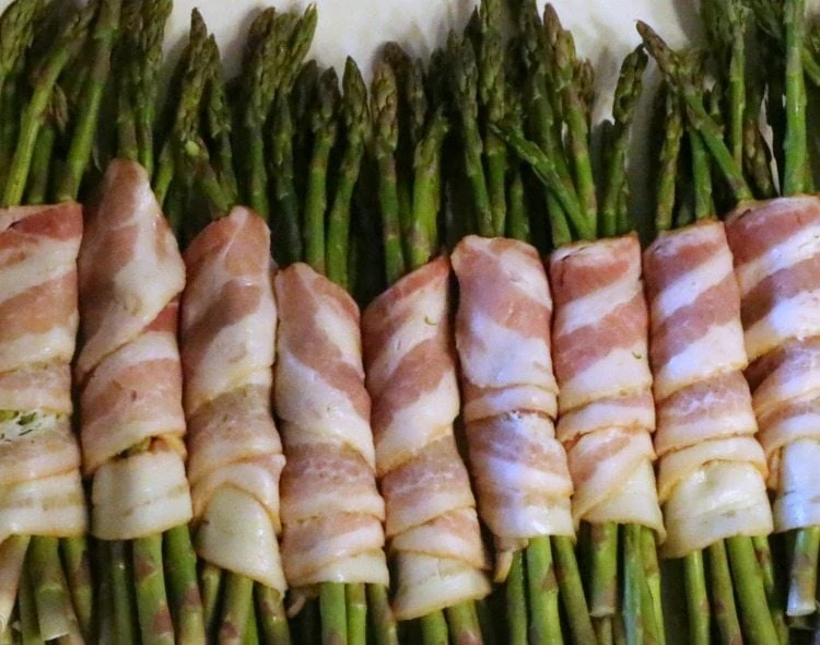 This bacon wrapped asparagus recipe is easy, but it tastes gourmet. With just three simple ingredients, you'll want to add this as a regular appetizer for parties or even as a light main dish for busy weeknights! 