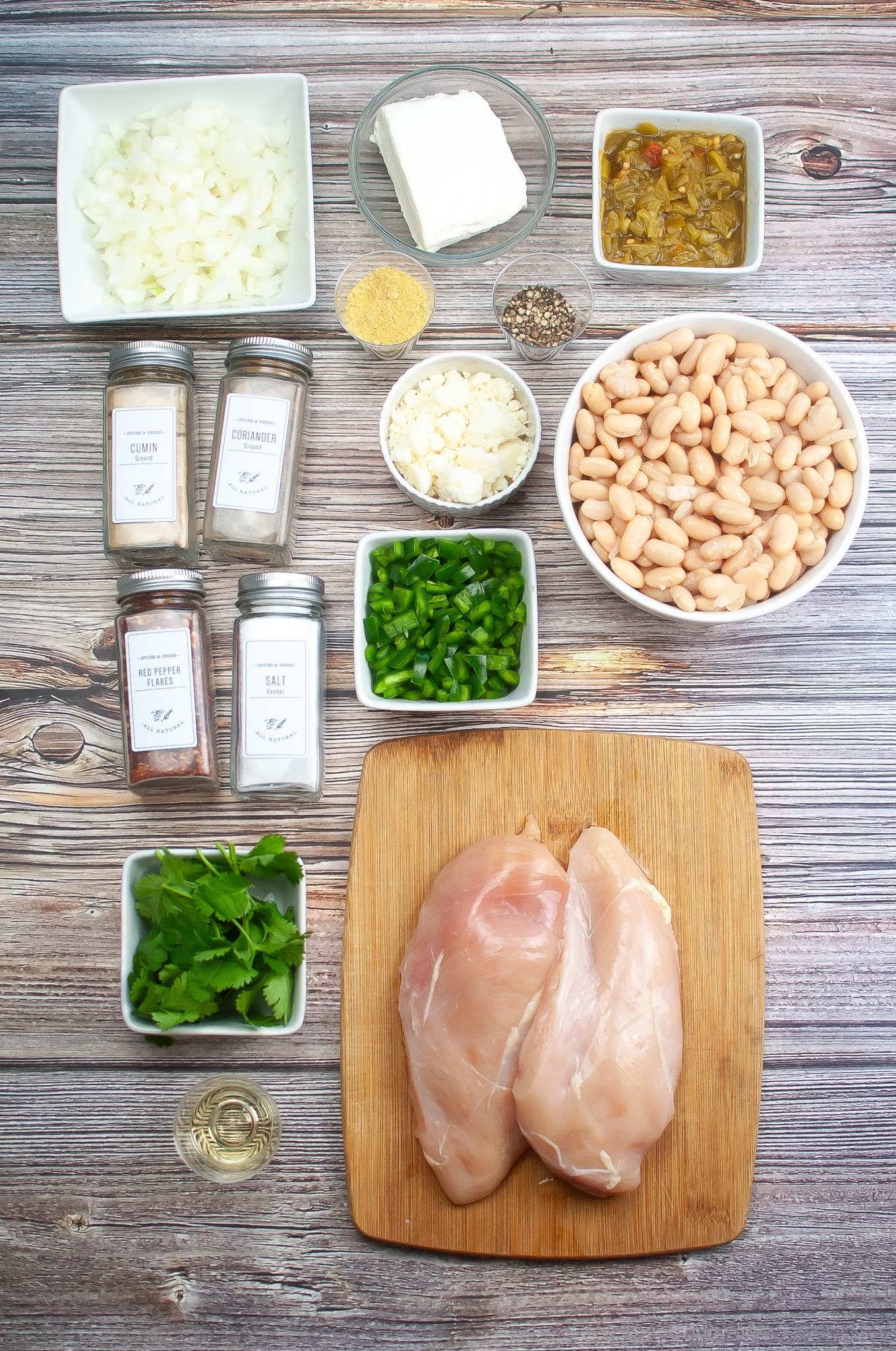 White Chicken Chili Chicken breast ingredients on a wooden cutting board.
