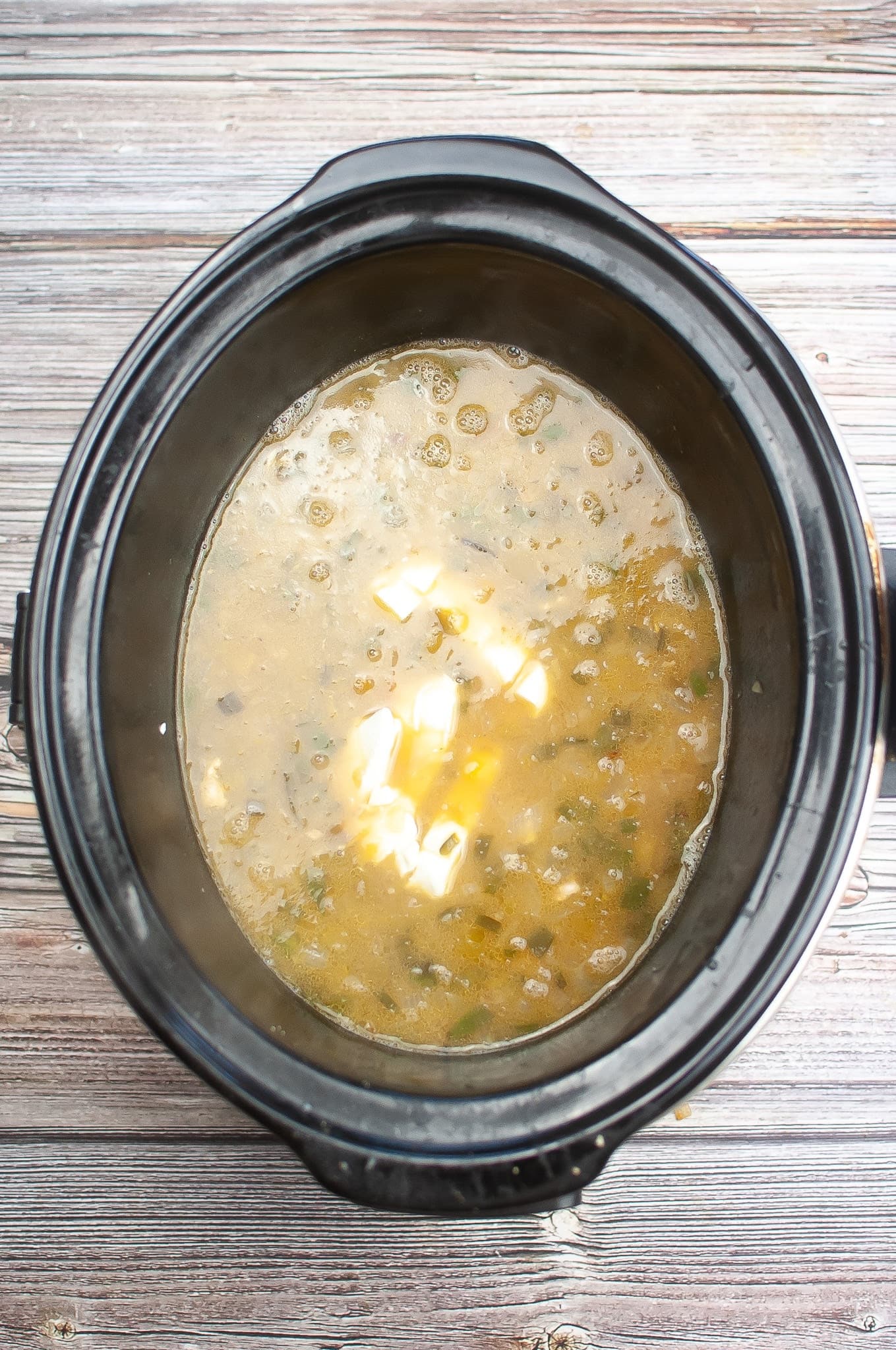 A crock pot of slow cooker white chicken chili.