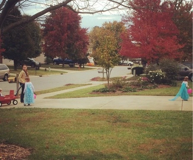 mother trick or treating with her children on Halloween