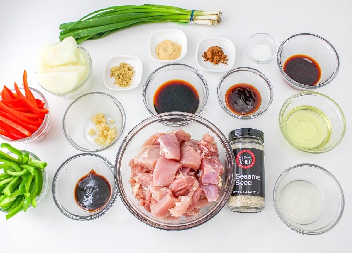 The ingredients for asian fried chicken are laid out on a white surface.