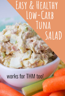 A bowl of low carb tuna salad with eggs, surrounded by celery and carrot sticks, labeled as easy, healthy, and suitable for THM diets.