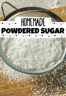 homemade powdered sugar inside a metal sifter on top of a cutting board