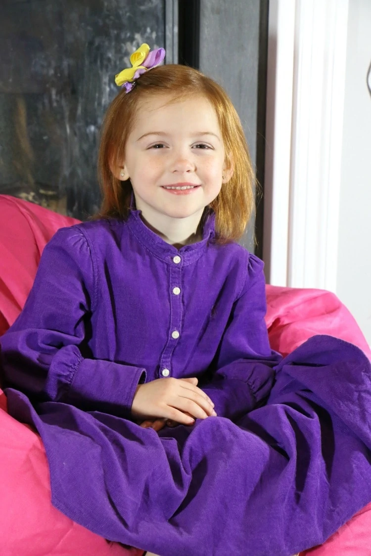 In her purple Schoola dress