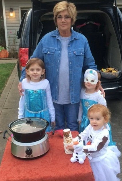 Grandmother with her three granddaughters on Halloween. 