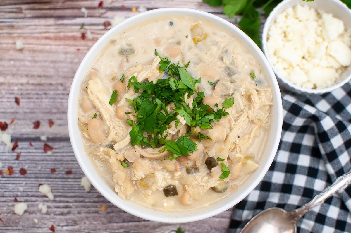 A bowl of slow cooker white chicken chili with white beans and chicken.