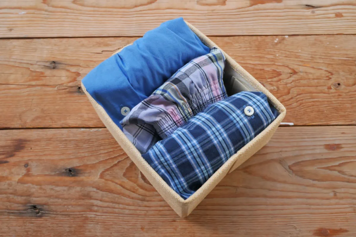 A subscription box of shirts is sitting on top of a wooden table.