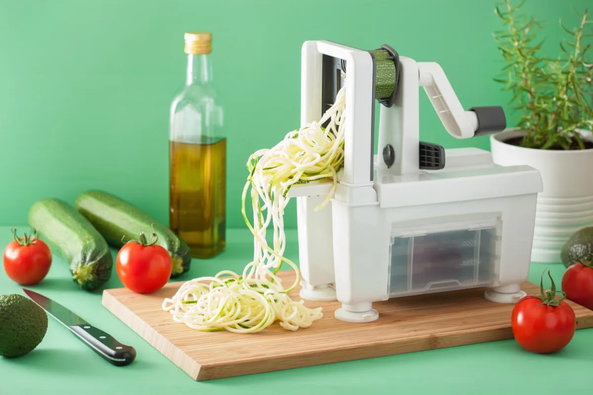 An image of a vegetable spiralizer on a cutting board.