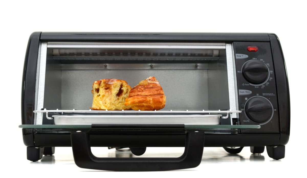 A toaster oven with a piece of bread in it.