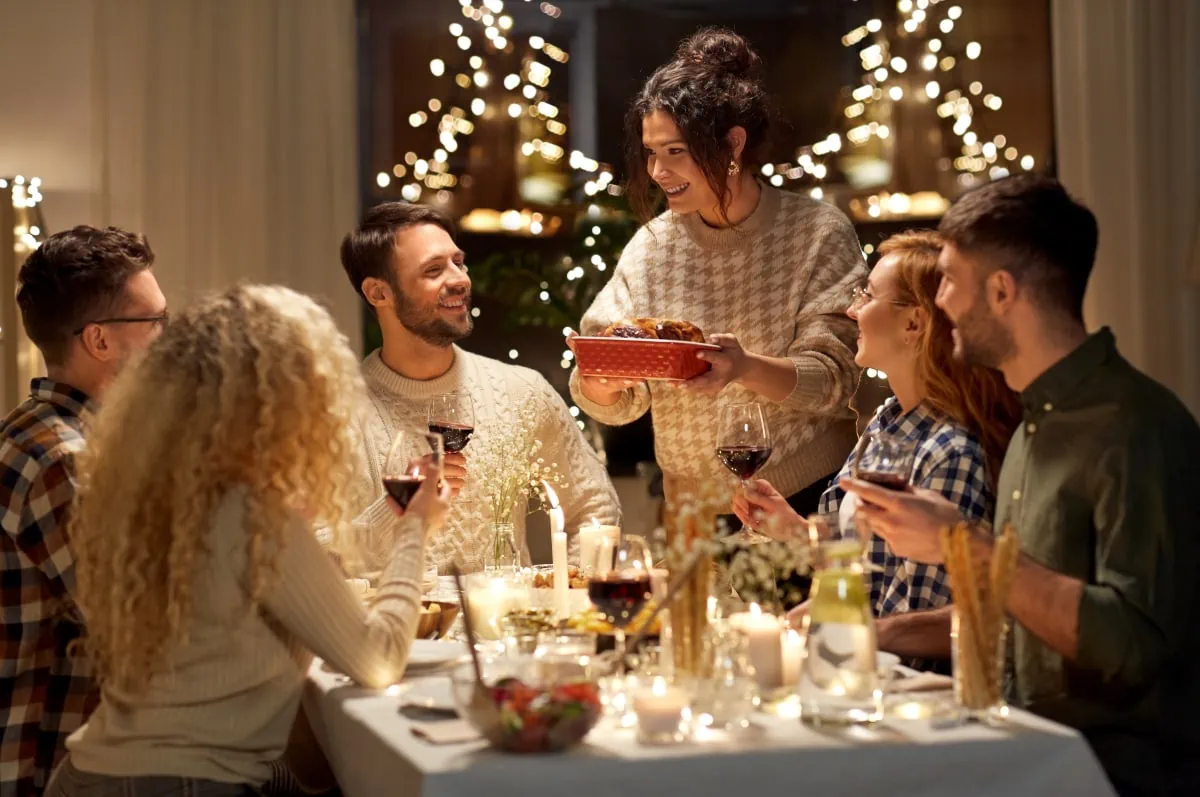 A group of people from the working poor sitting around a table at a Christmas dinner.