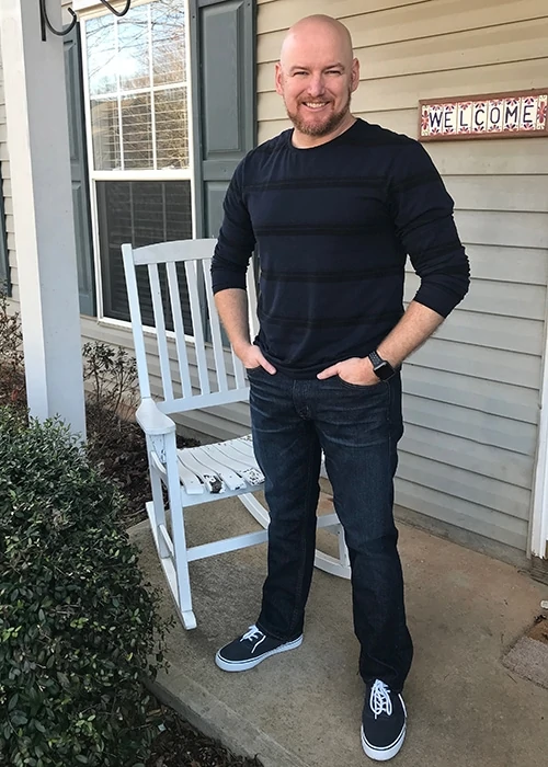 A man standing on a front porch modeling clothing from Stitch Fix for Men. 