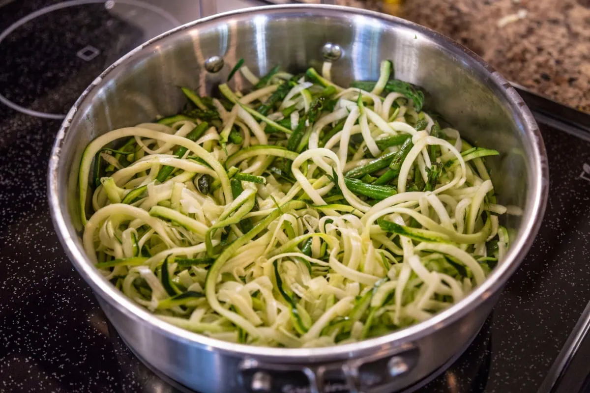 Zero waste cooking with zucchini noodles on a stove top.
